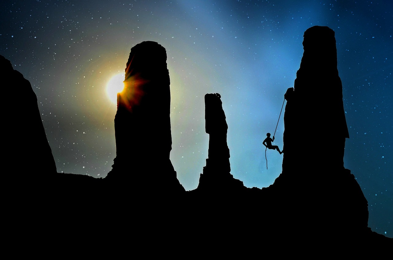 mountaineer, dark sky and mesas. By Anja on Pixabay.  https://pixabay.com/photos/mountaineer-climb-rock-climber-2100050/